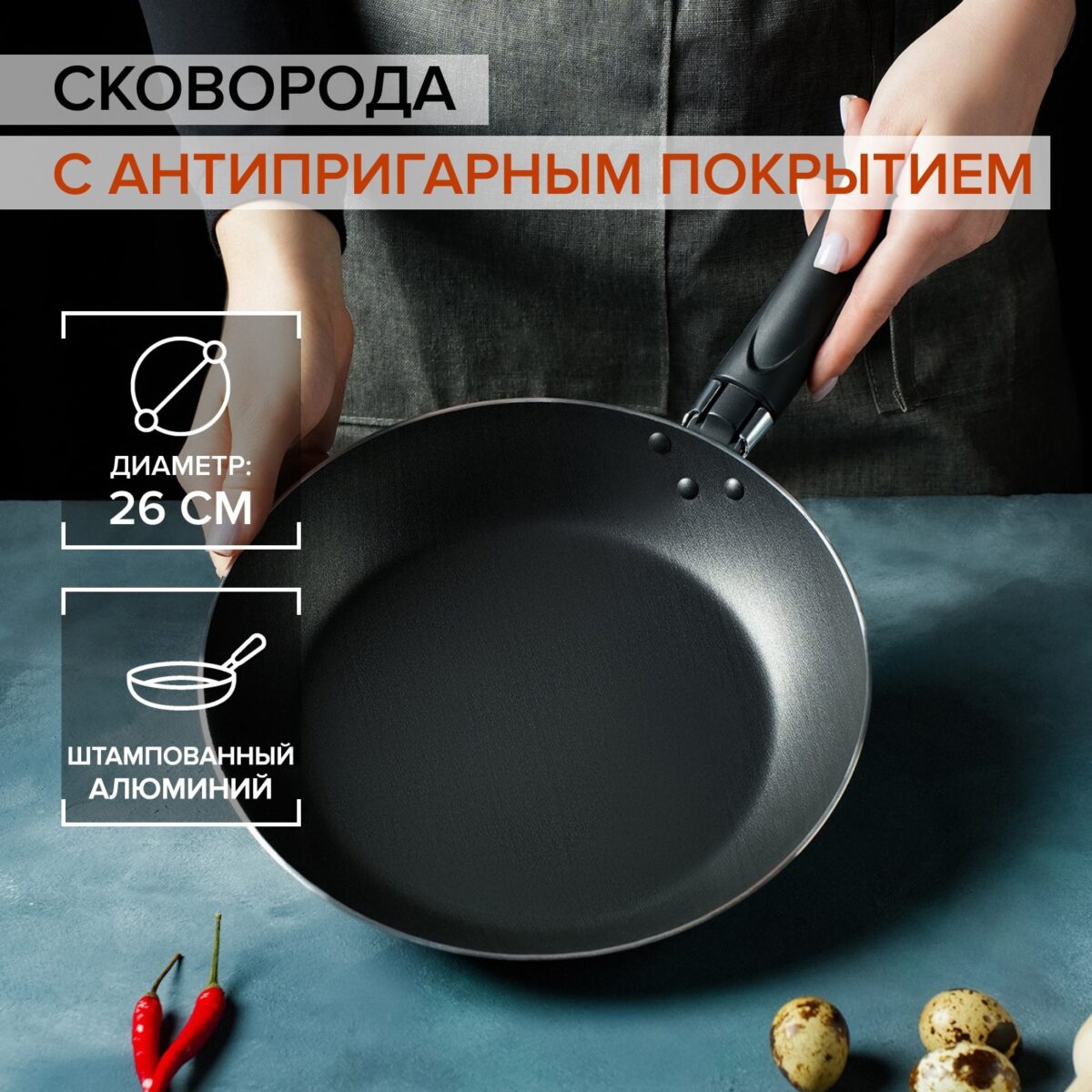 Черная сковорода из штампованного алюминия с антипригарным покрытием и эргономичной пластиковой ручкой на сером фоне